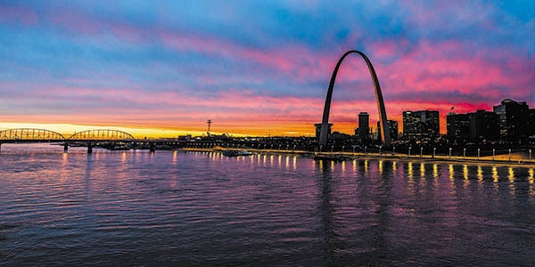 The graceful St. Louis Arch reflected on the vast Mississippi