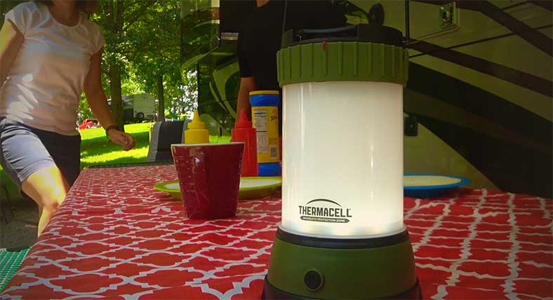 Thermacel L camping light on picnic bench with motorhome in background