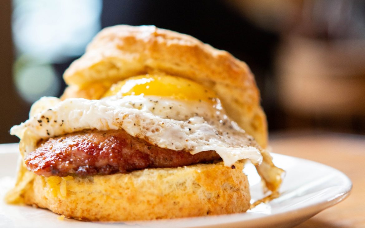 Biscuit with egg and sausage on plate