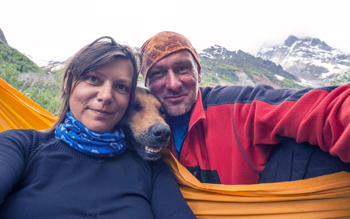 Man and woman smiling selfie with dog