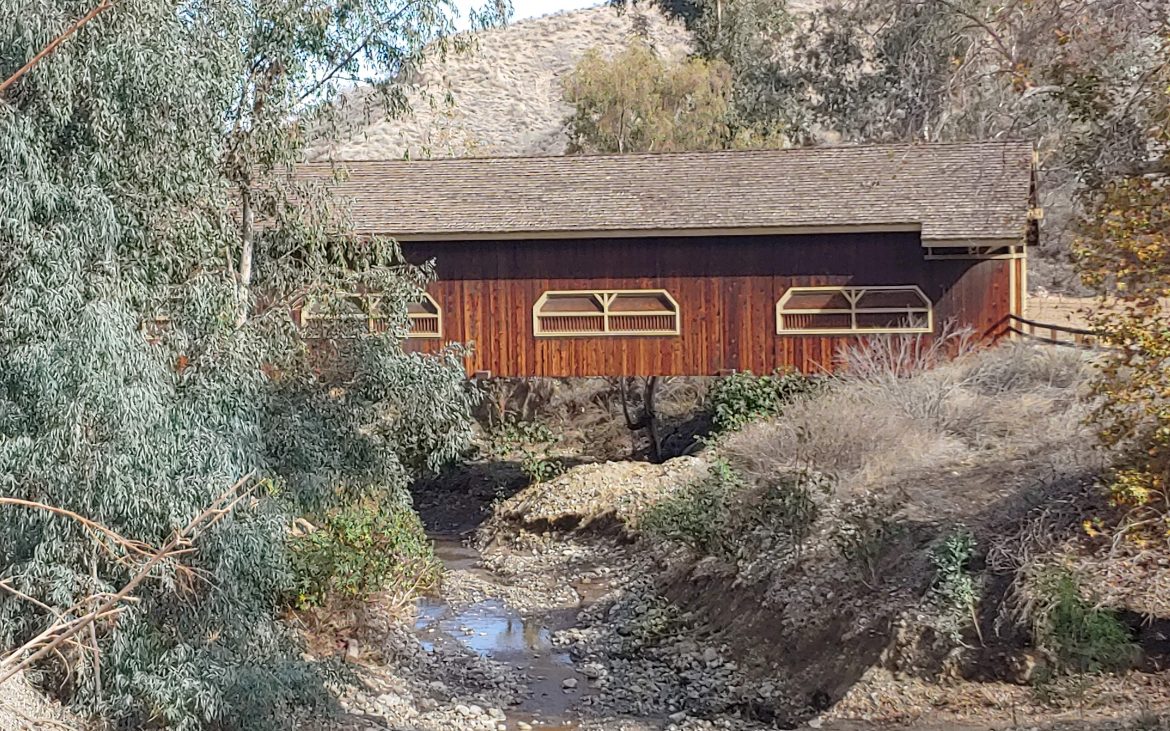 Wooden bridge house over a small creek