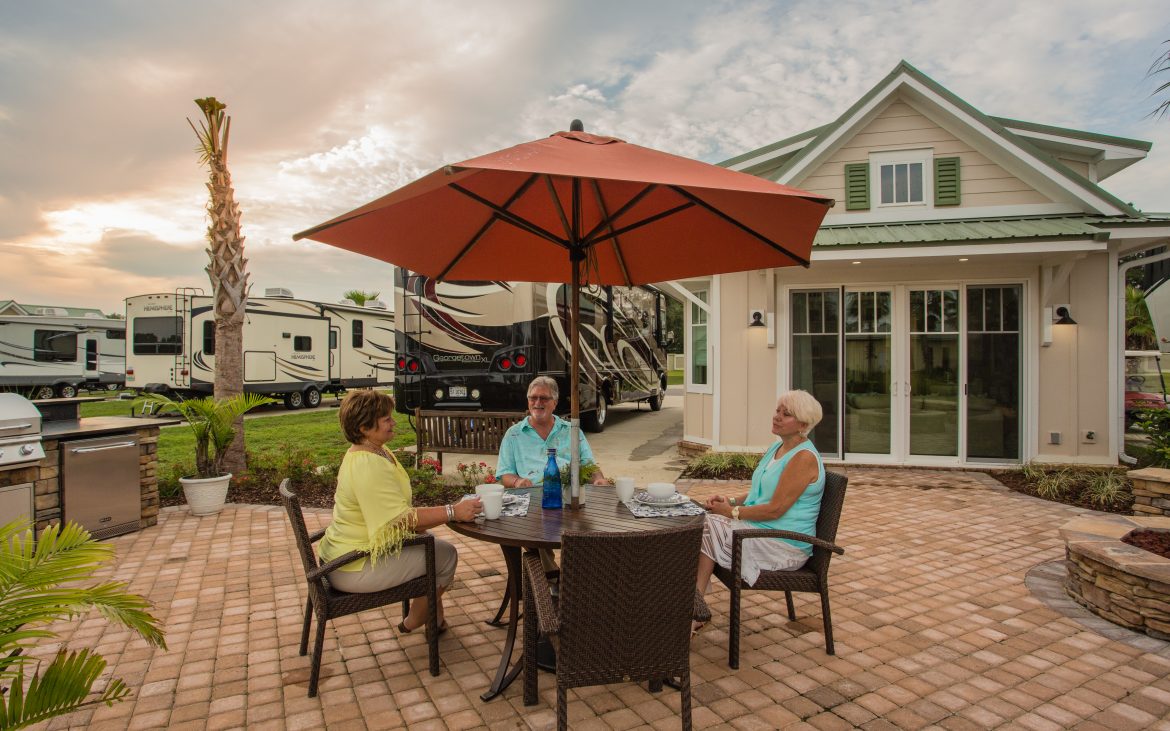 Elderly women sitting around a patio table at the Osprey RV Resort clubhouse