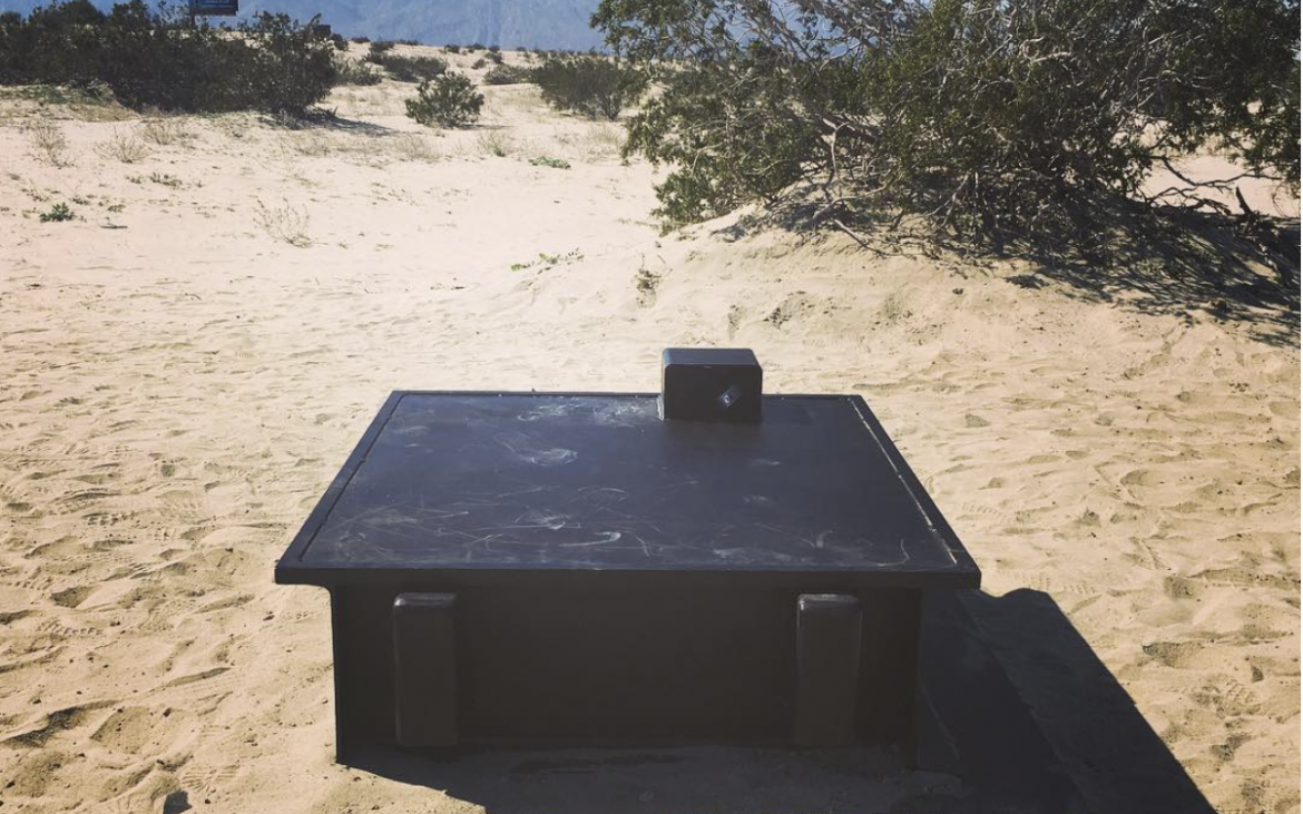 Black bunker in the Southern California desert sand