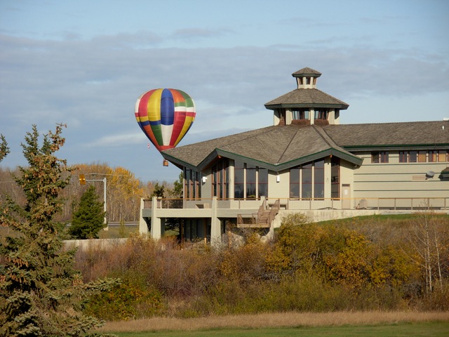 Clubhouse with colorful air balloon floating behind it.