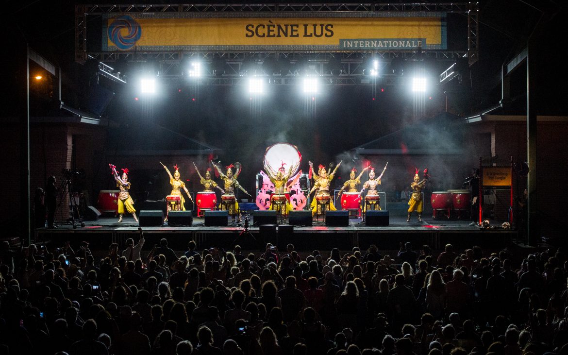 Colorful dancers performing on large well-lit stage