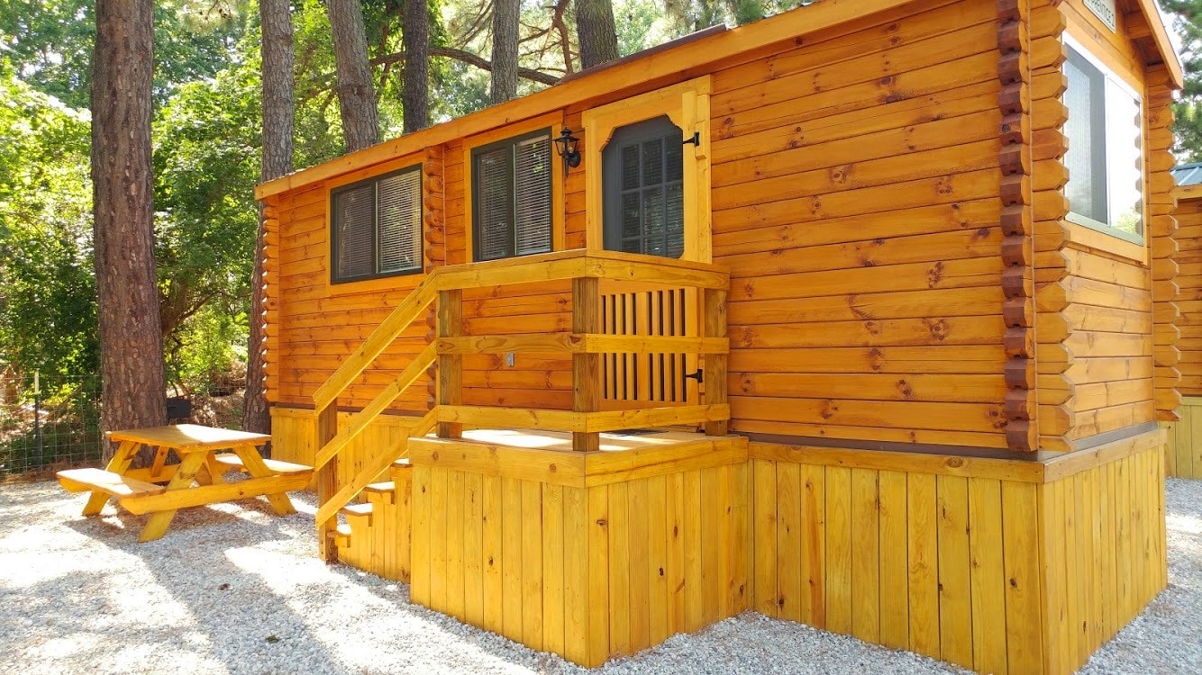 A camping cabin with a smooth wooden exterior.