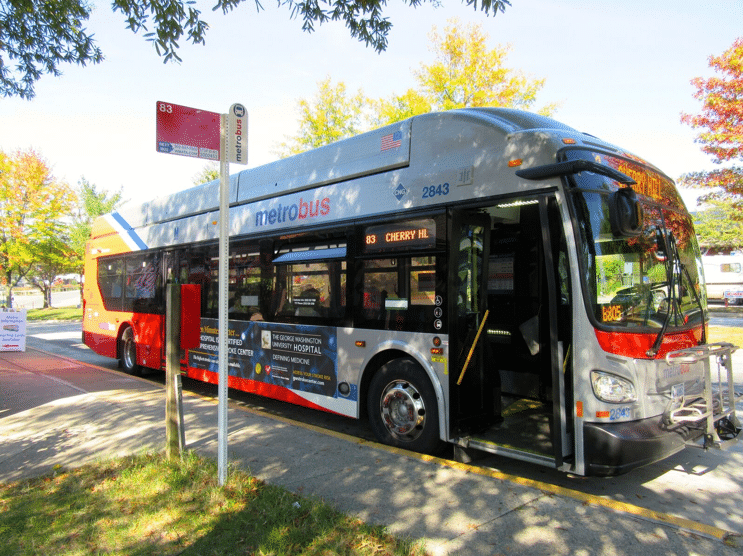 Large gray and red public bus