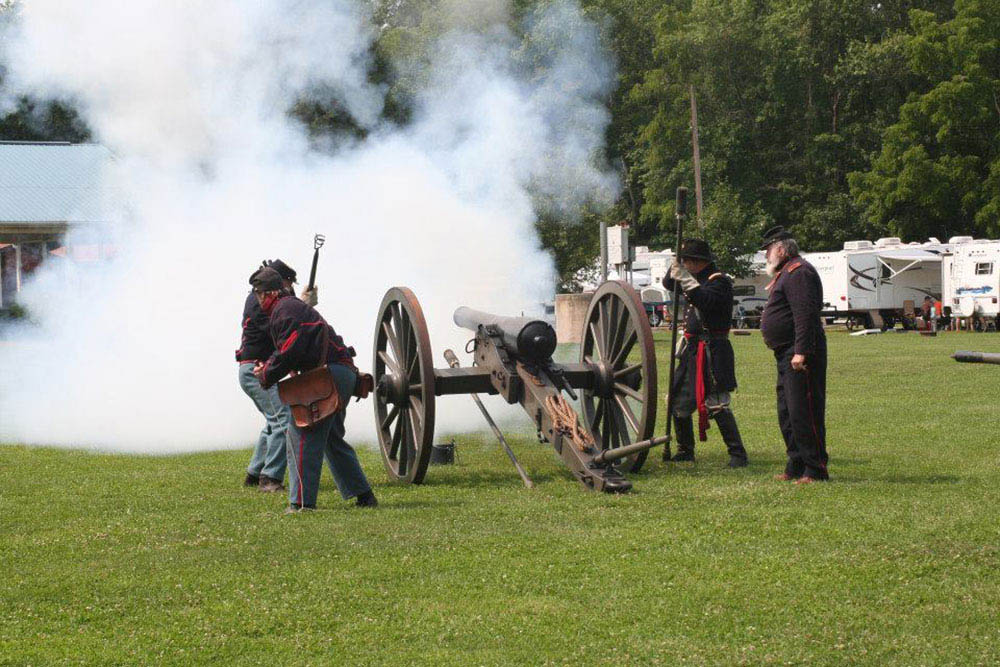 Men participating in firing a canon during civil war reenactment