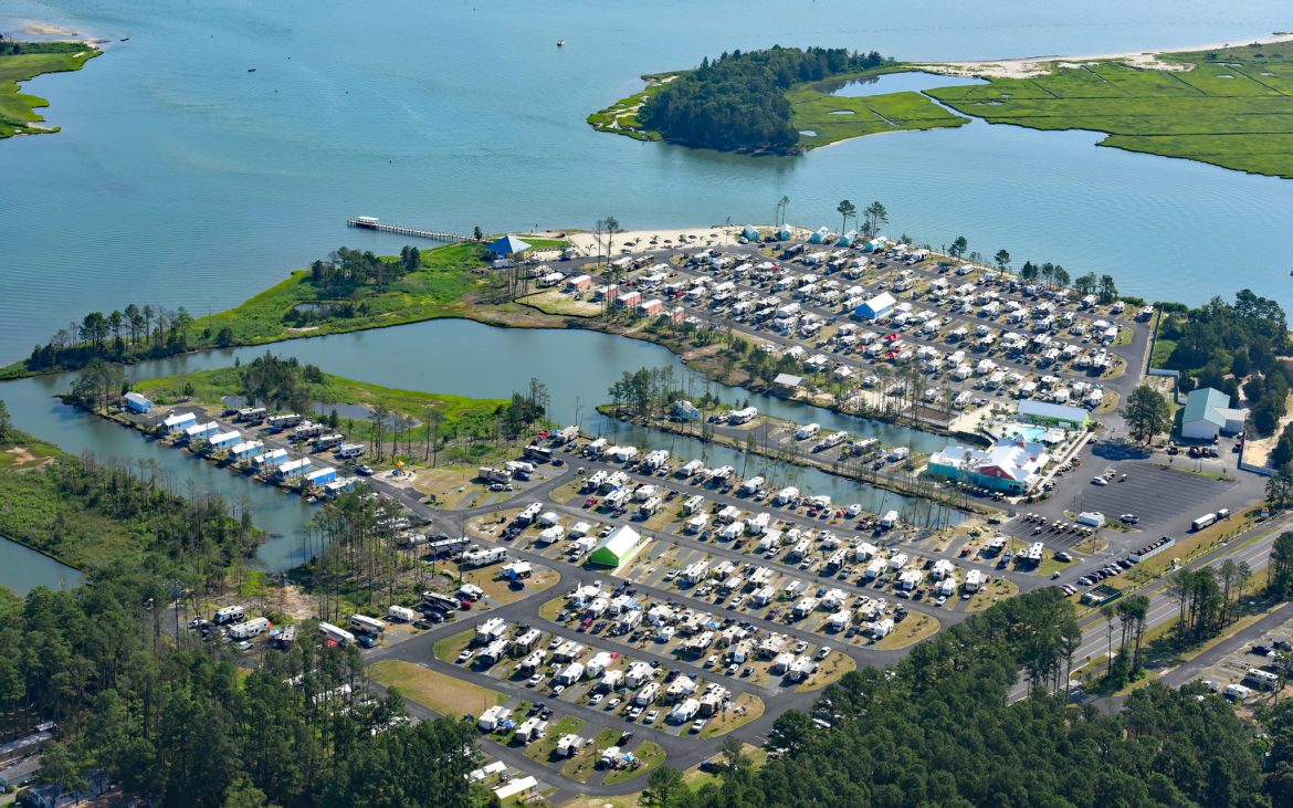 Stunning aerial photo of many RVs and Trailers parked along rows 
