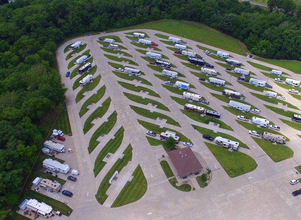 Aerial view of many RVs parked in spaces along paved roads
