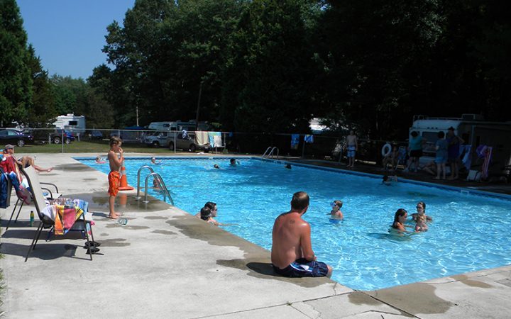 Campers swimming playfully in community pool