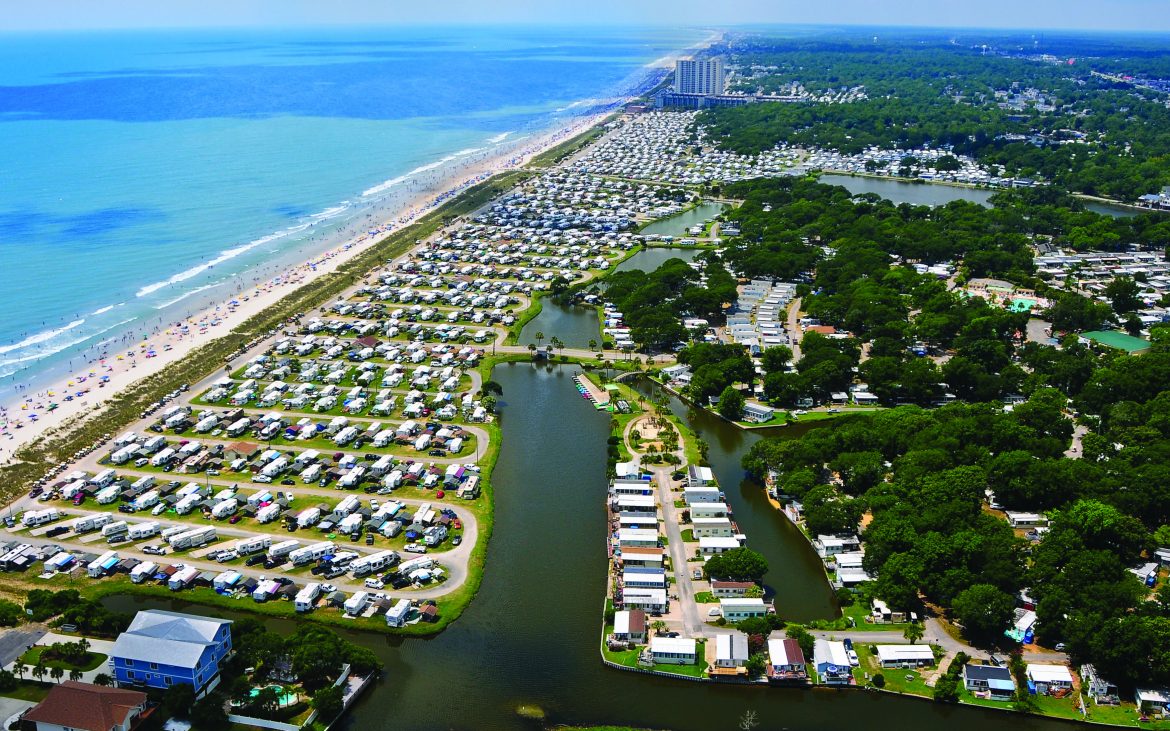Sweeping aerial view of campground with ocean in background