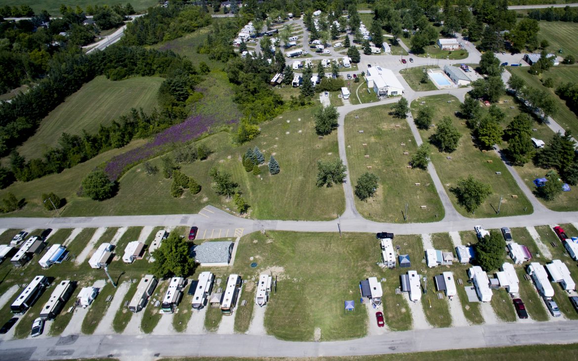 Aerial view of many RVs and trailers parked in stalls