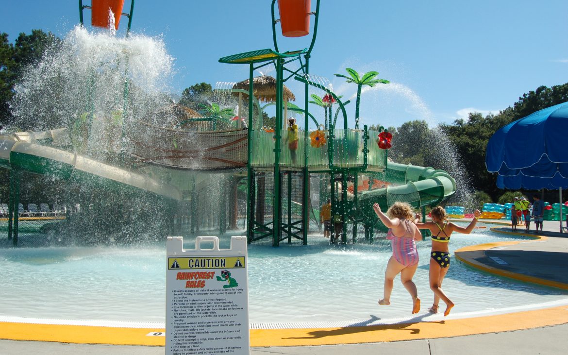 Children playing at colorful waterpark splash pad