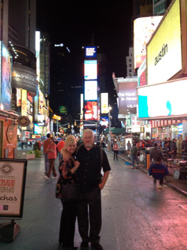 A couple on a sidewalk in Times Square in Manhattan.
