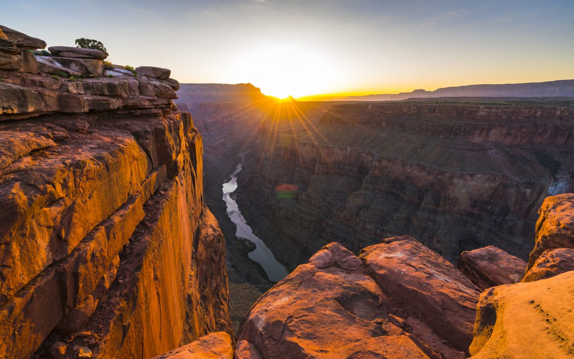 Beautiful sunrise at Grand Canyon with high cliffs and rocks