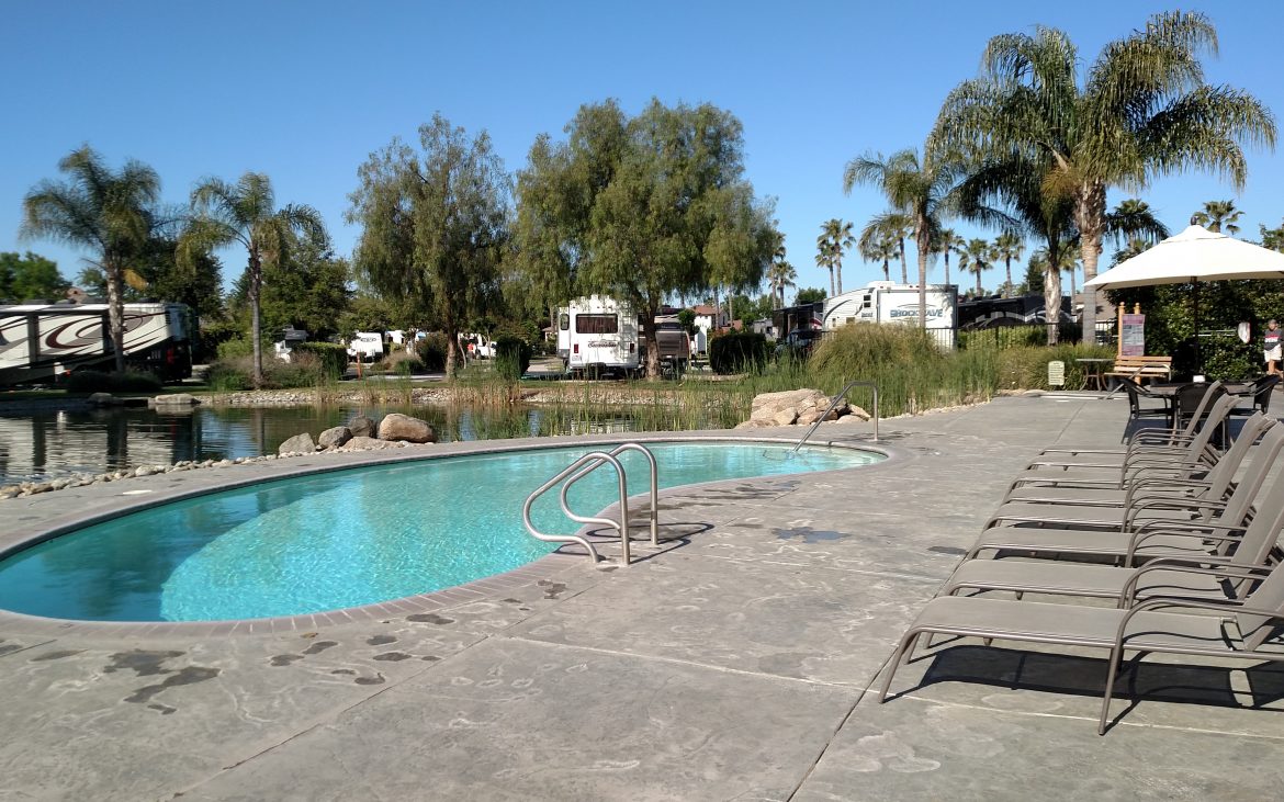 Clean community pool with RV and Trailers in the background