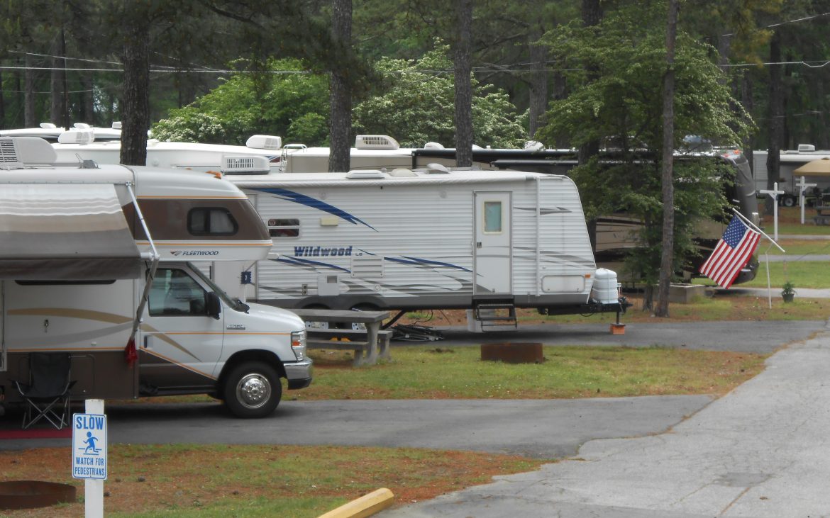 RV and Trailer parked along paved road