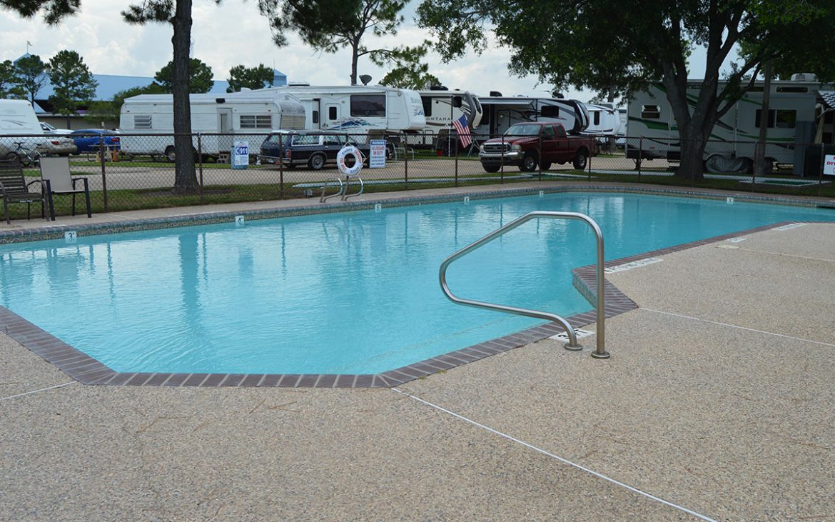 Clean community pool with RVs in background