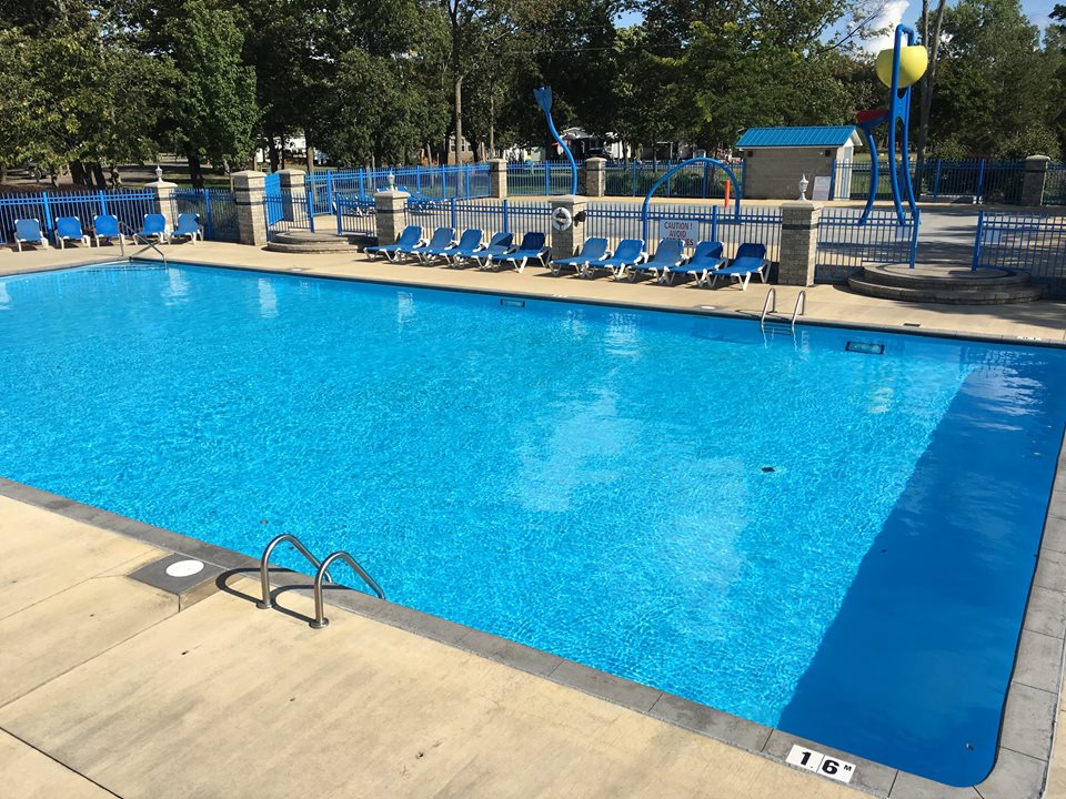Gleaming water of community pool surrounded by lounge chairs