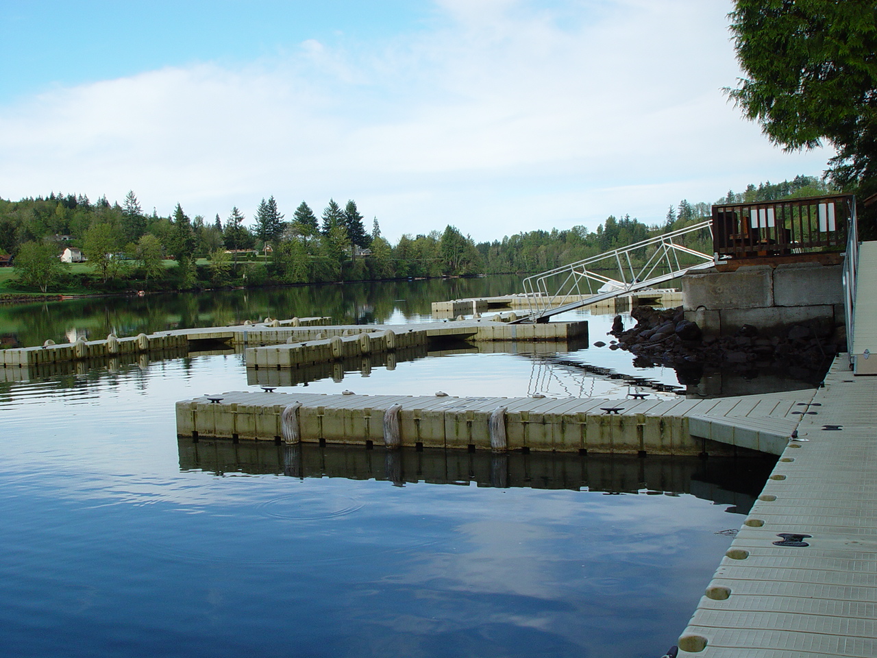 Wooden boat docks on glassy calm lake