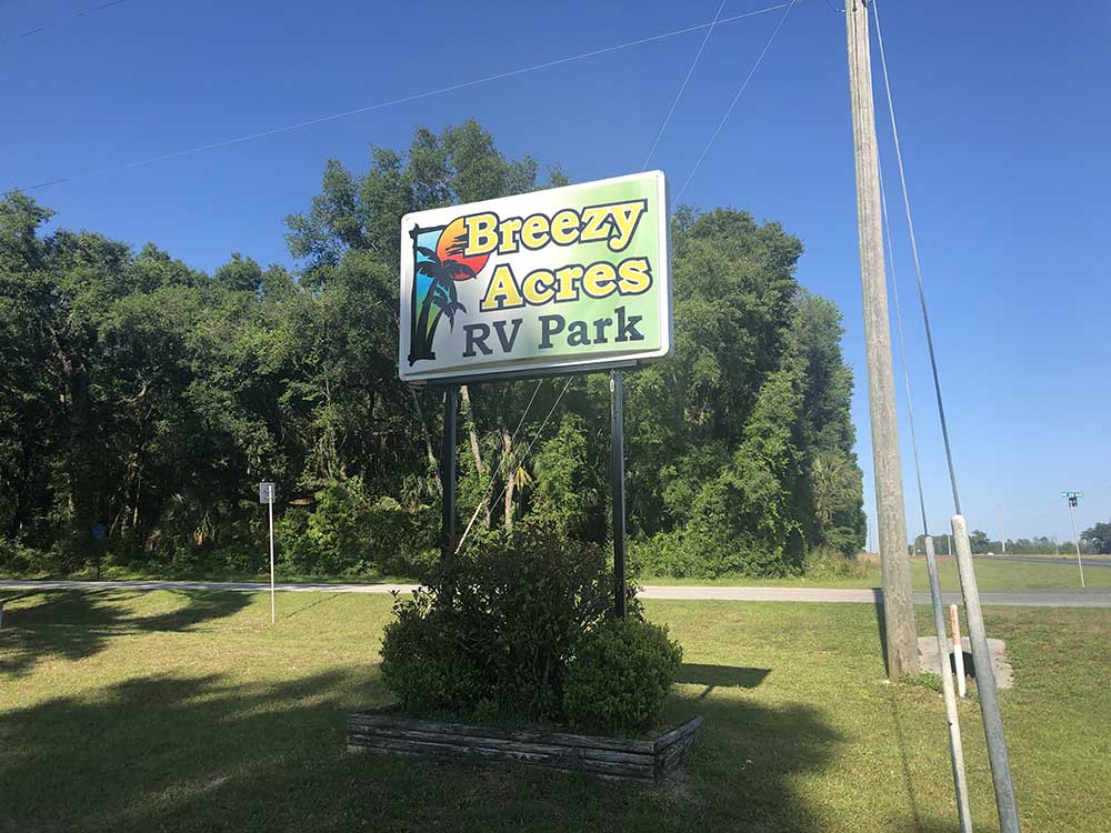 Breezy Acres RV Park Sign welcomes visitors to a lush, green RV park.