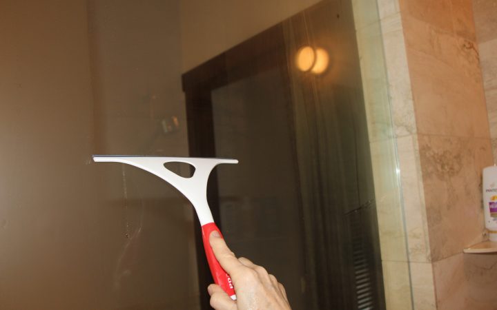 A squeegee used to clear the glass of an RV shower stall.