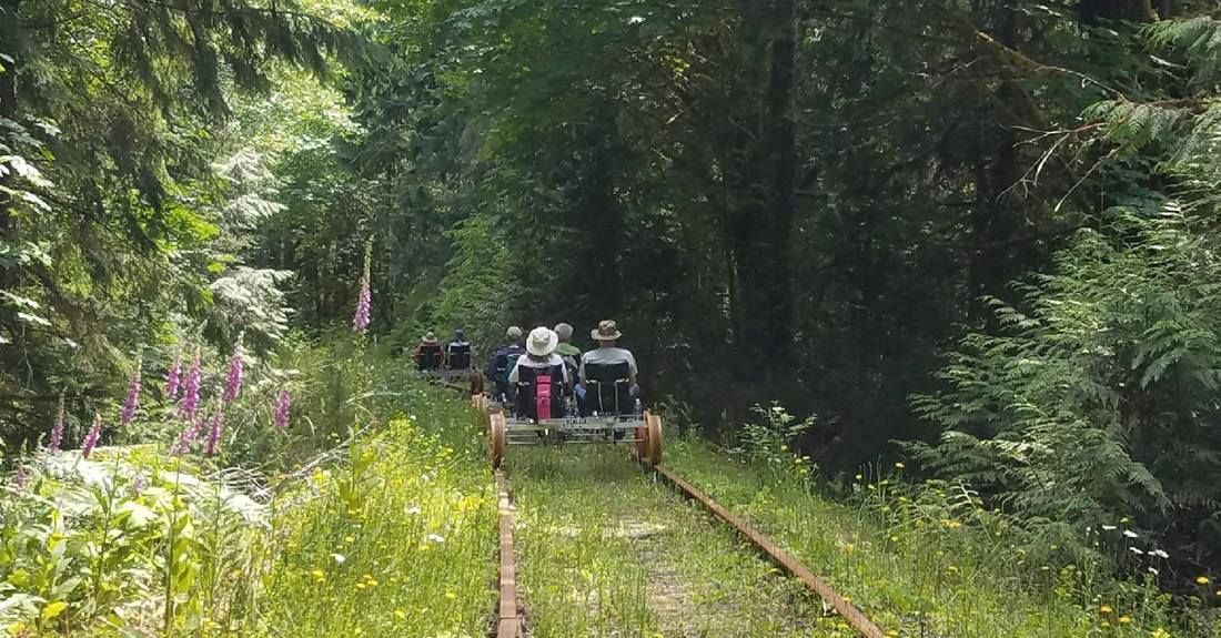 Riding the rails through a lush Oregon forest.