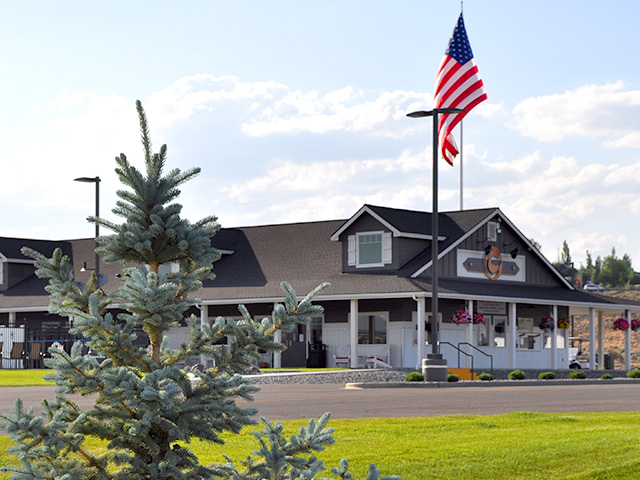 Large cottage style building with American Flag