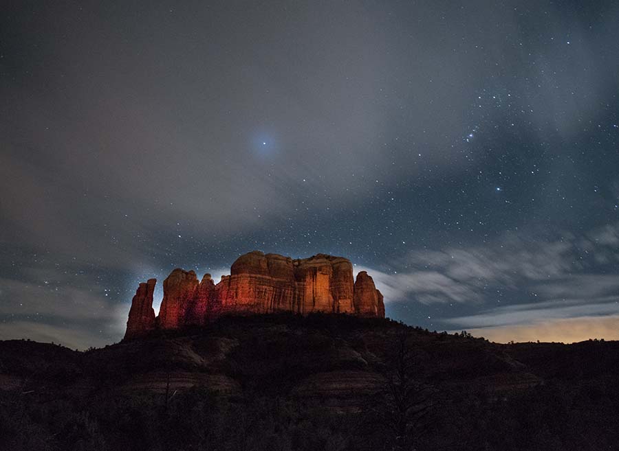 Cathedral Rock looms against the night sky for hiking in the American Southwest.