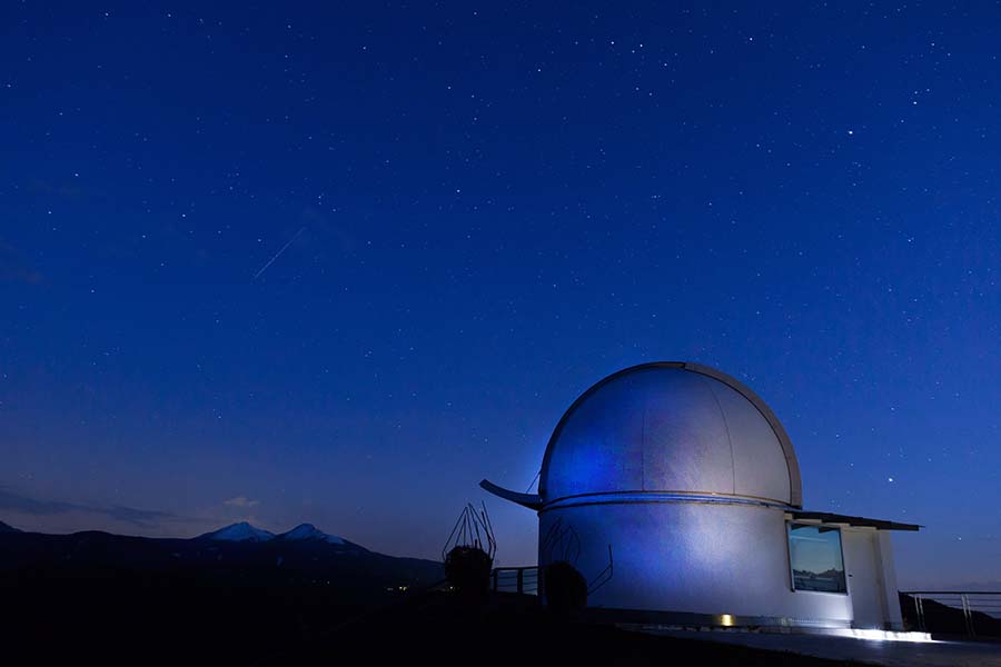 The Palomar Observatory sits under the stars of a night sky.