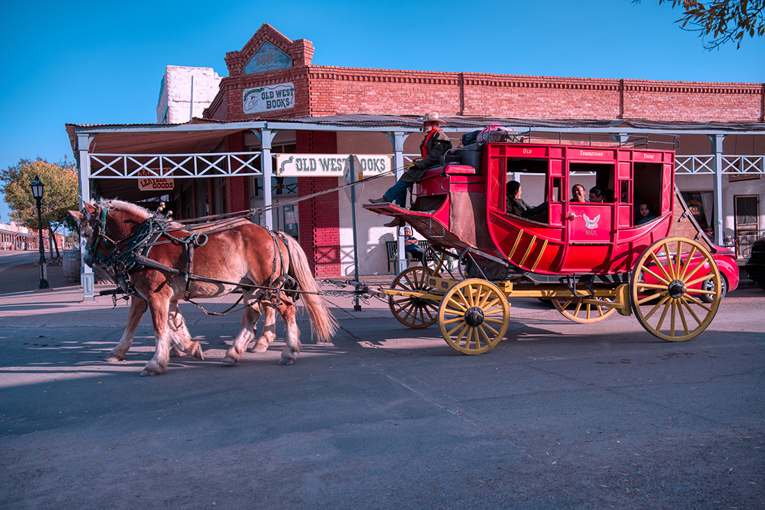 A bright red stagecoach rumbles through Tombstone, Arizona.