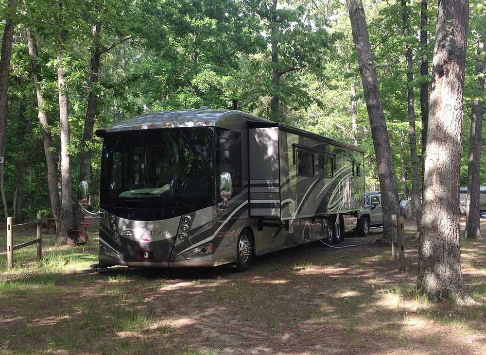 Large RV parked in the woods