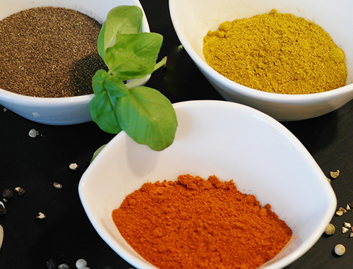 Three bowls filled with an array of spices for extra flavor.