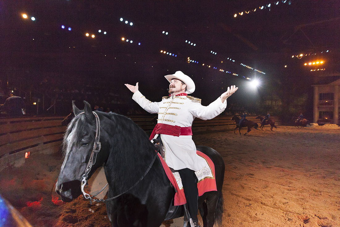 A man on horseback dressed in a Civil War uniform greets the crowd during a Branson performance.