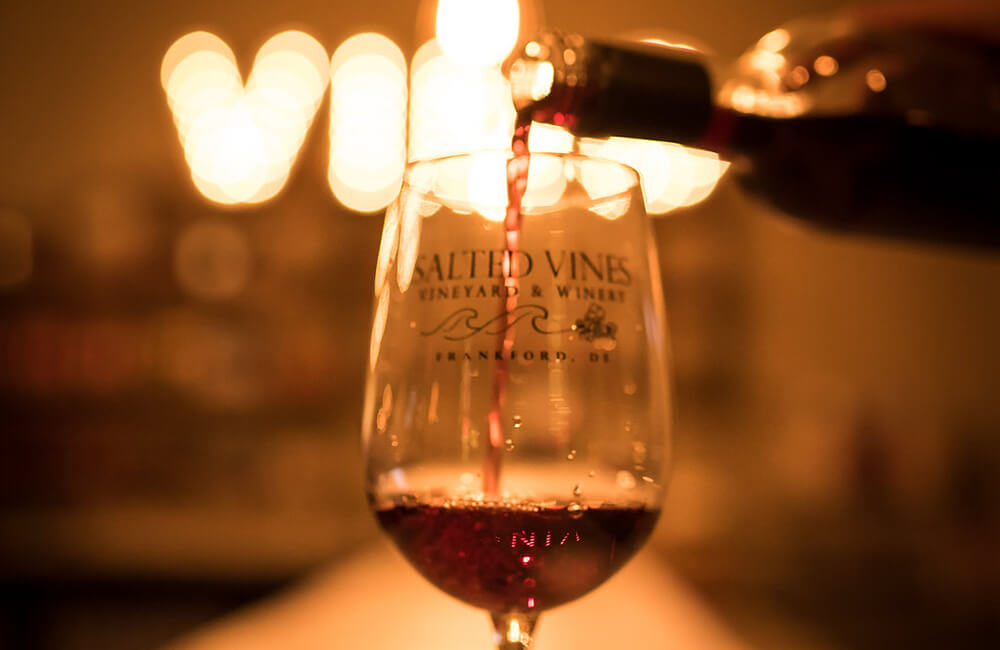 Close up of red wine pouring in wine glass