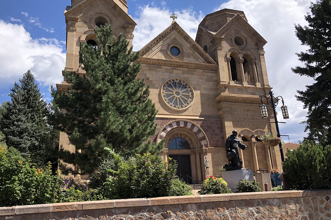The impressive stone facade of historic Cathedral Basilica of St. Francis of Assisi in Santa Fe.