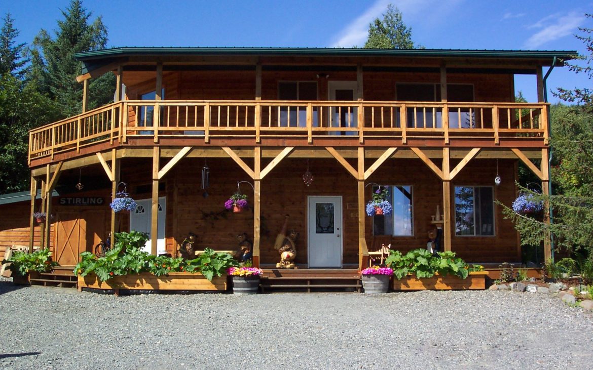 Two story wooden building with nice planters in front