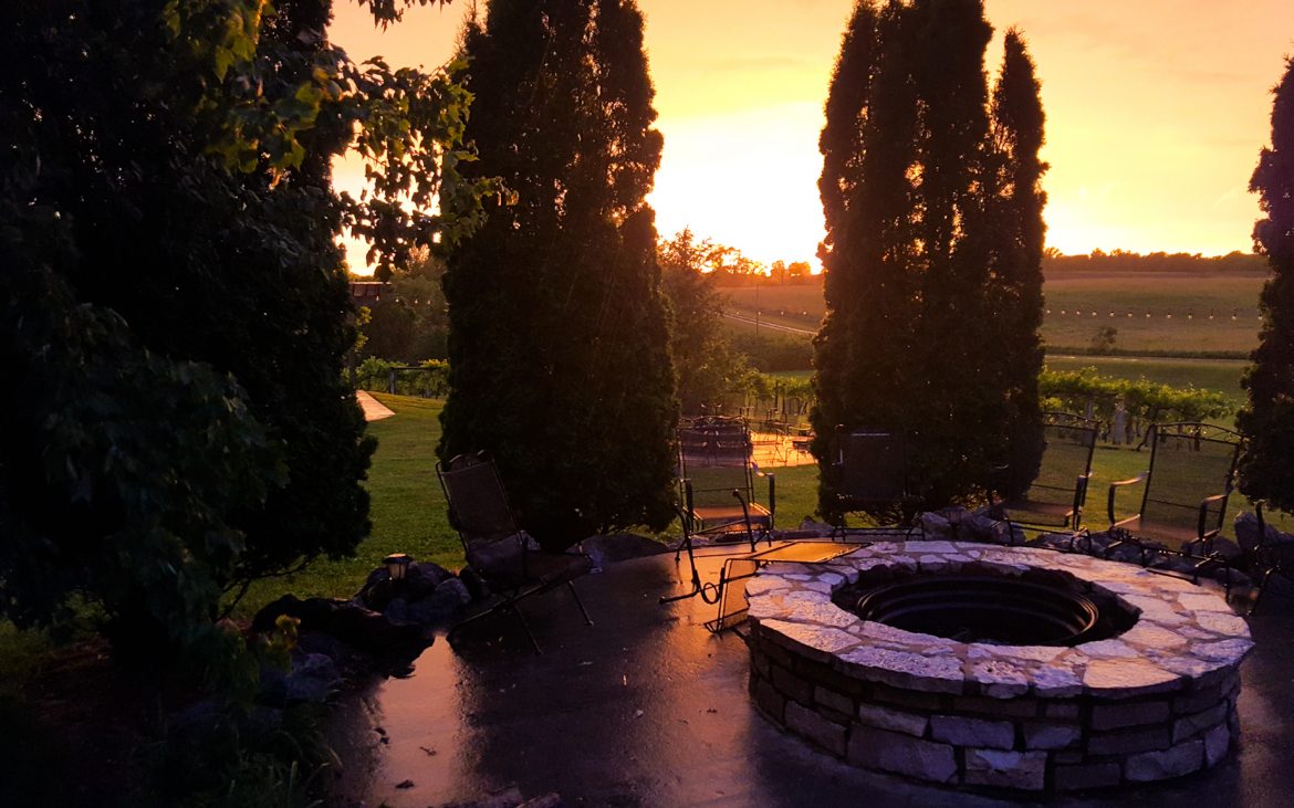 Sunset amidst winery and fire pit