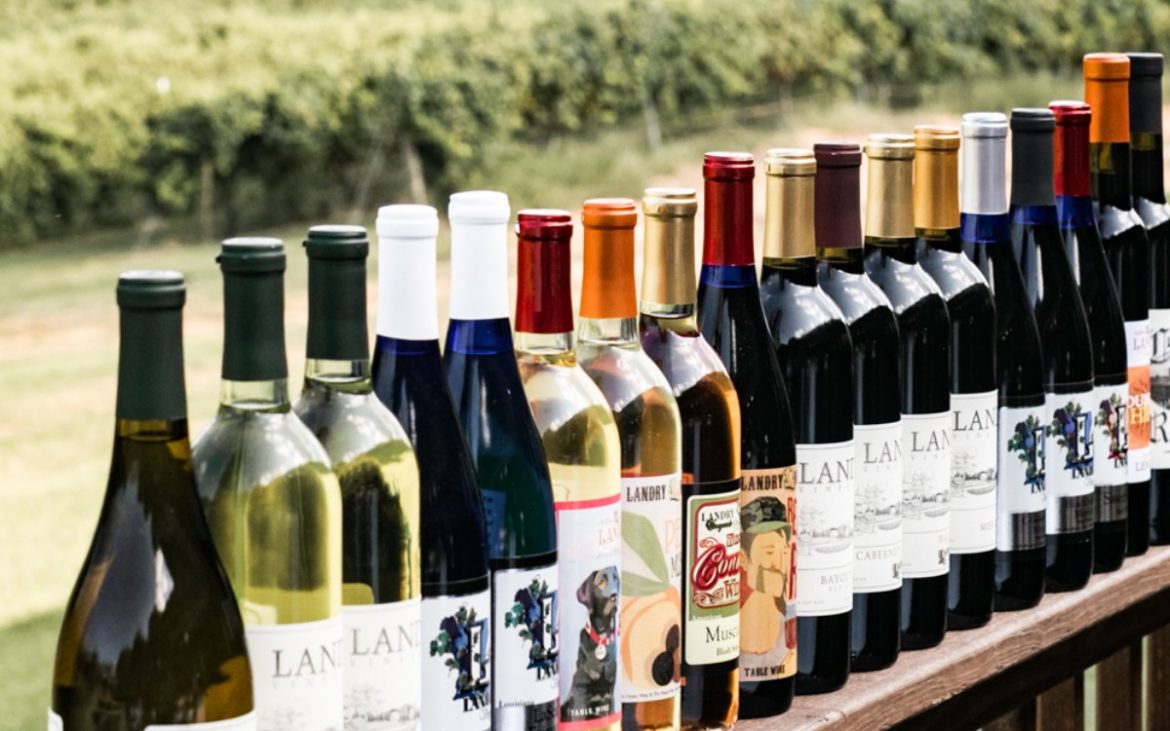 Row of wine bottles placed on outside railing