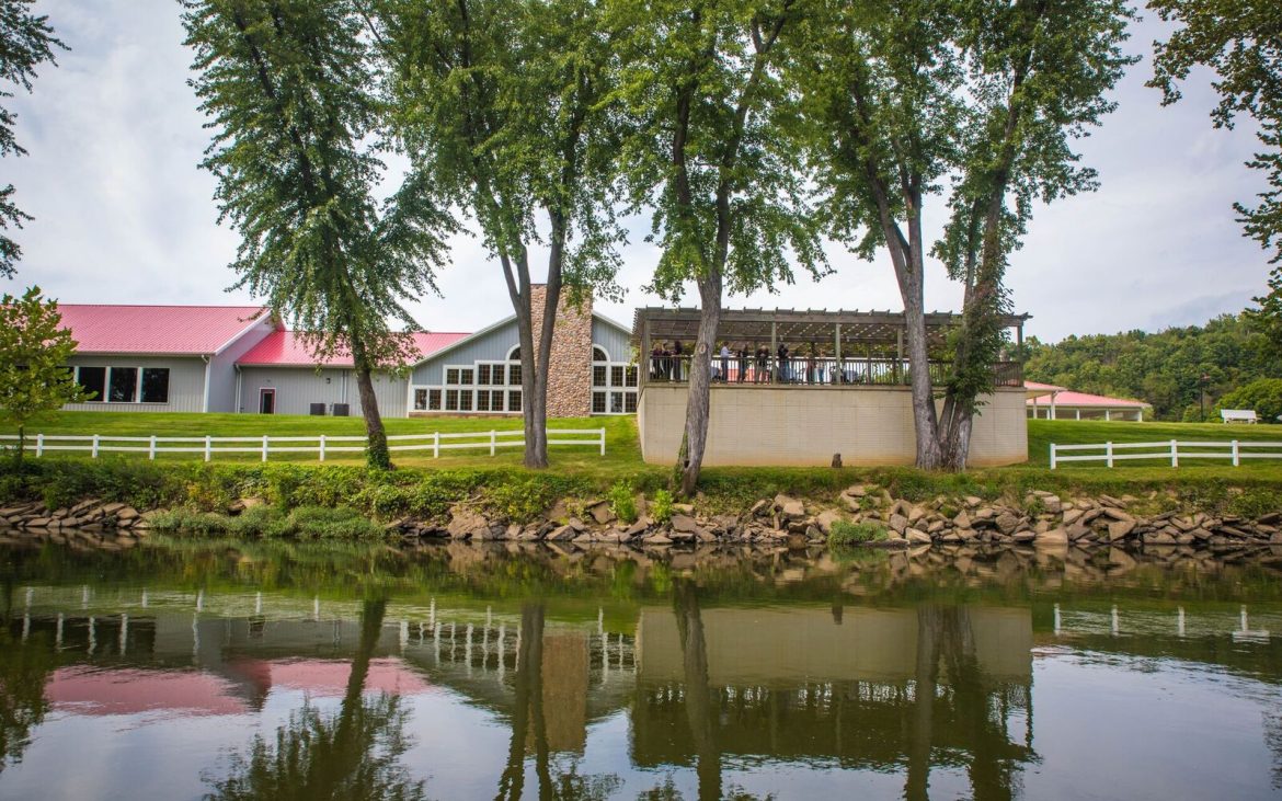 Lake view from winery building with trees and outdoor patio