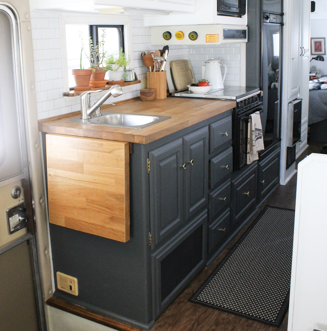 A rug covers the passage leading through the galley of a motorhome.
