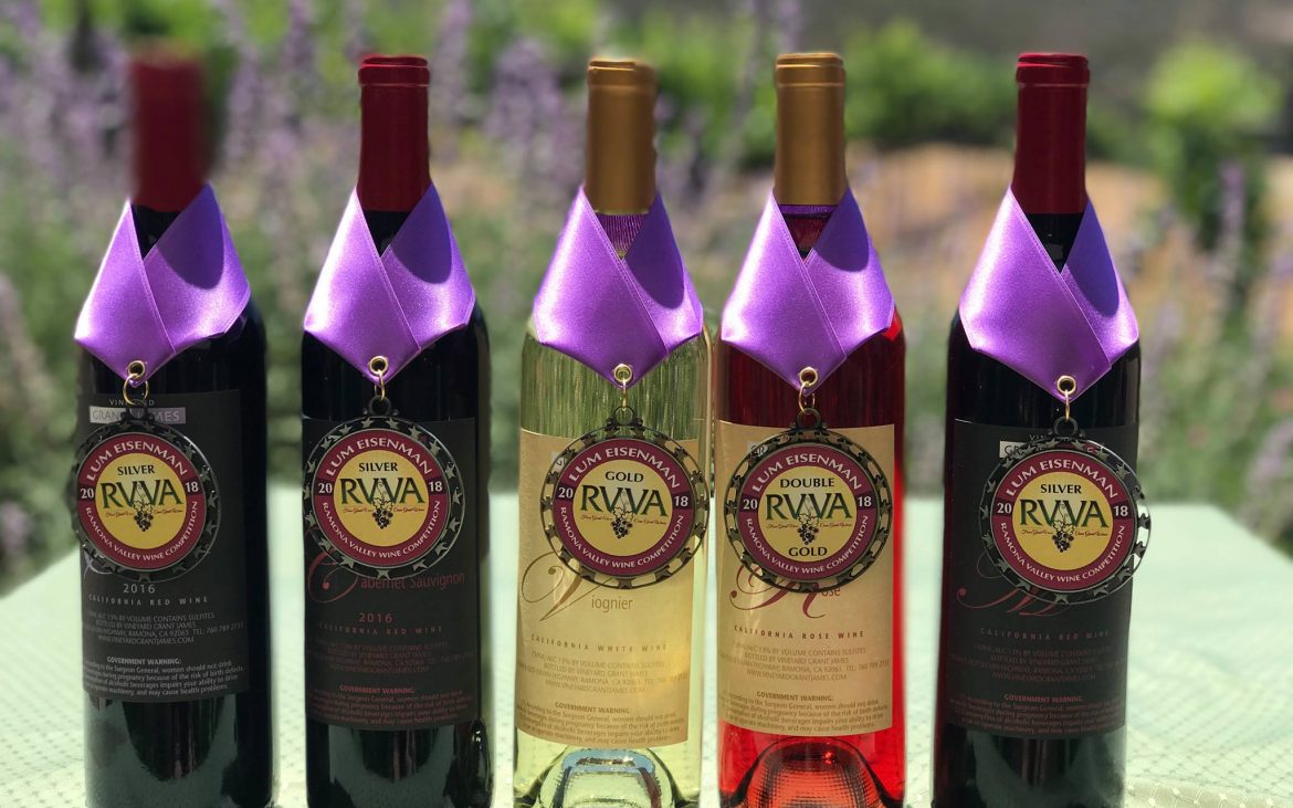 Wine bottles displayed with medals