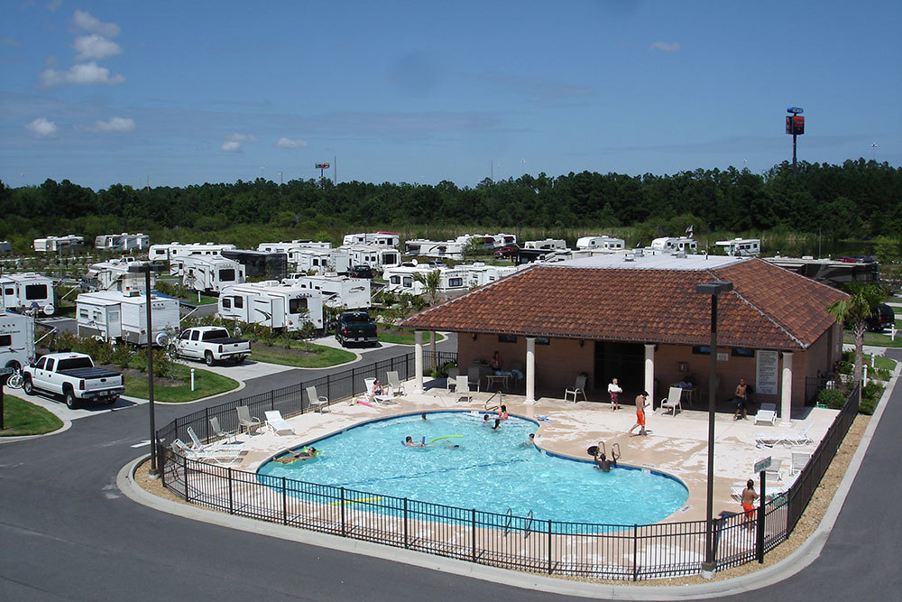 A pool in an RV park with bathers enjoying the water.