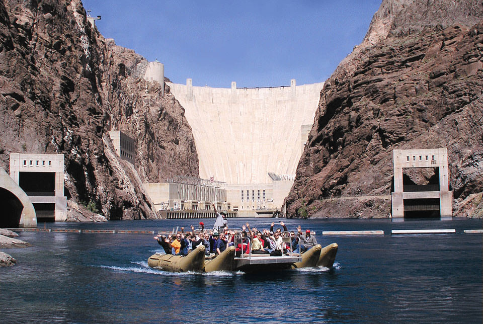 Rafters wave to the camera at the foot of the Hoover Dam.