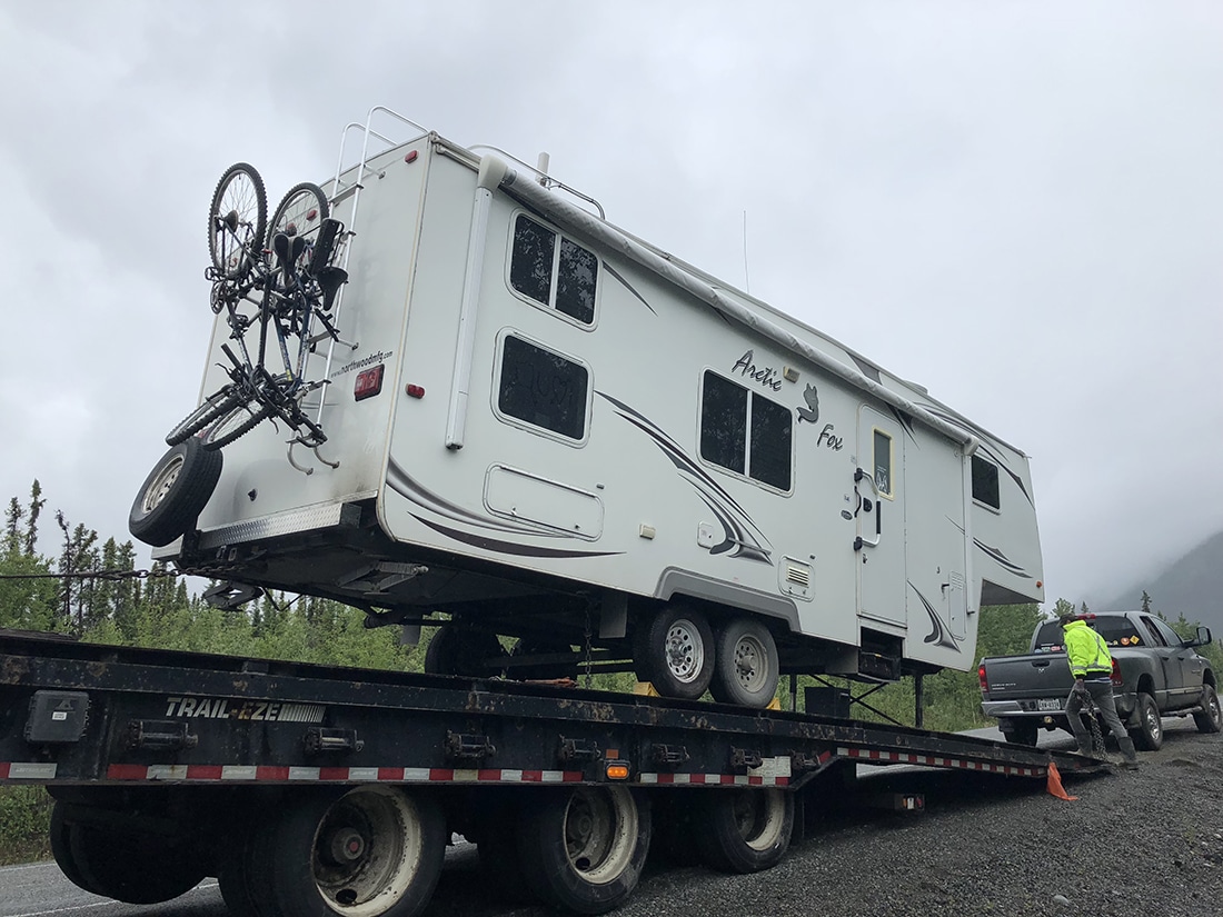 An RV on a trailer after repairs.
