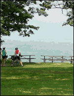 Cyclists taking a break on picnic bench at top of Mound, Blue Mounds, WI