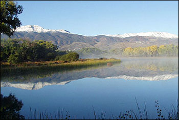 view of dead horse ranch state park with lagoon and snow-topped mountains