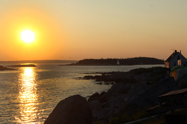 Sunset at Peggy's Cove.  Note the lighthouse at right.