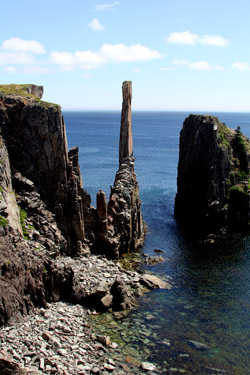 A dramatic spire rises from the waters of Spillar's Cove